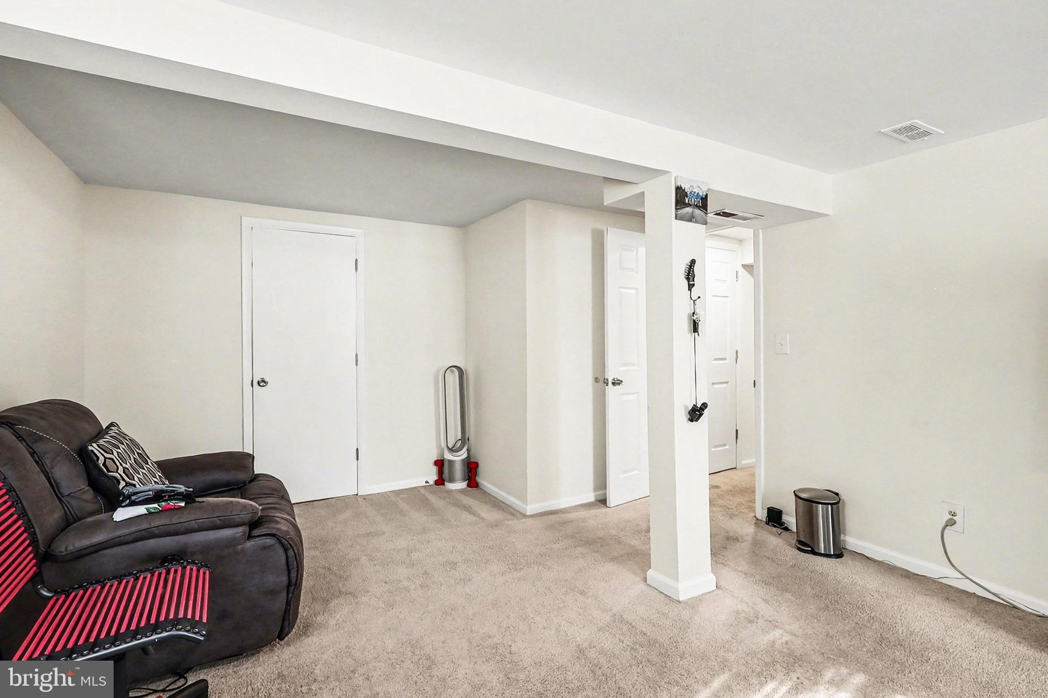 7112 Dalhouse Street Springfield, VA 22151 - Photo 19 of 25 a room with a couch and a walk in closet