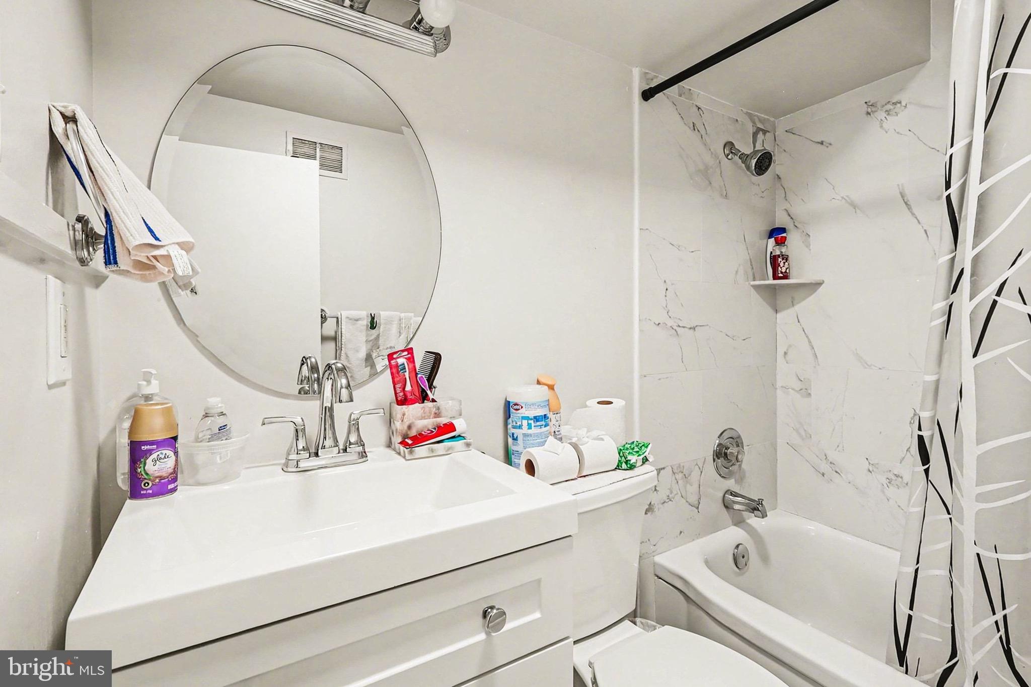 7112 Dalhouse Street Springfield, VA 22151 - Photo 21 of 25 a bathroom with a sink vanity mirror and toilet