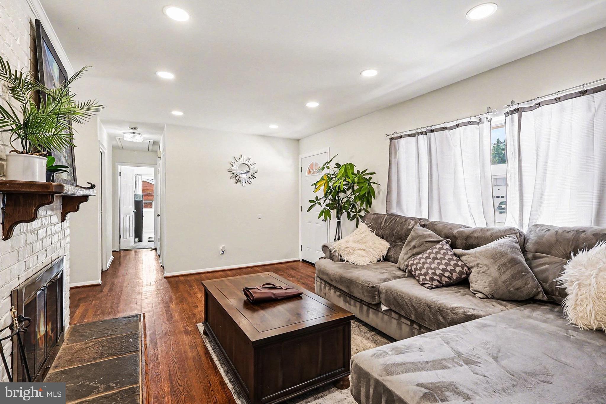 7112 Dalhouse Street Springfield, VA 22151 - Photo 3 of 25 a living room with furniture and a flat screen tv