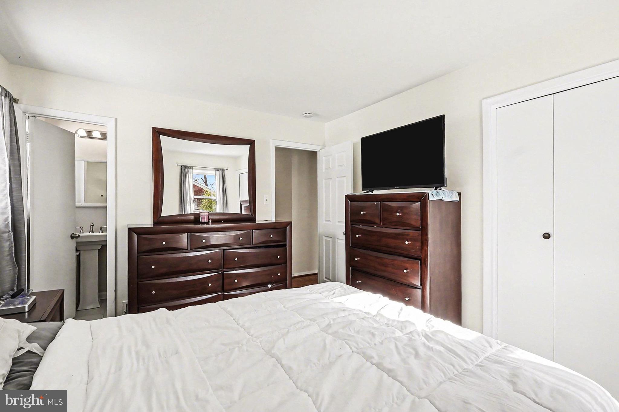 7112 Dalhouse Street Springfield, VA 22151 - Photo 9 of 25 a bedroom with a bed and a television