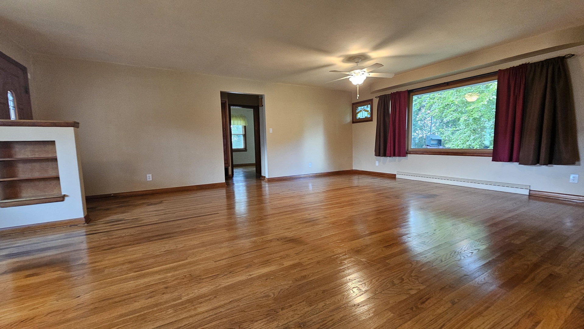 13658 East Flagg Road Rochelle, IL 61068 - Photo 13 of 65 a view of an empty room with wooden floor and a window