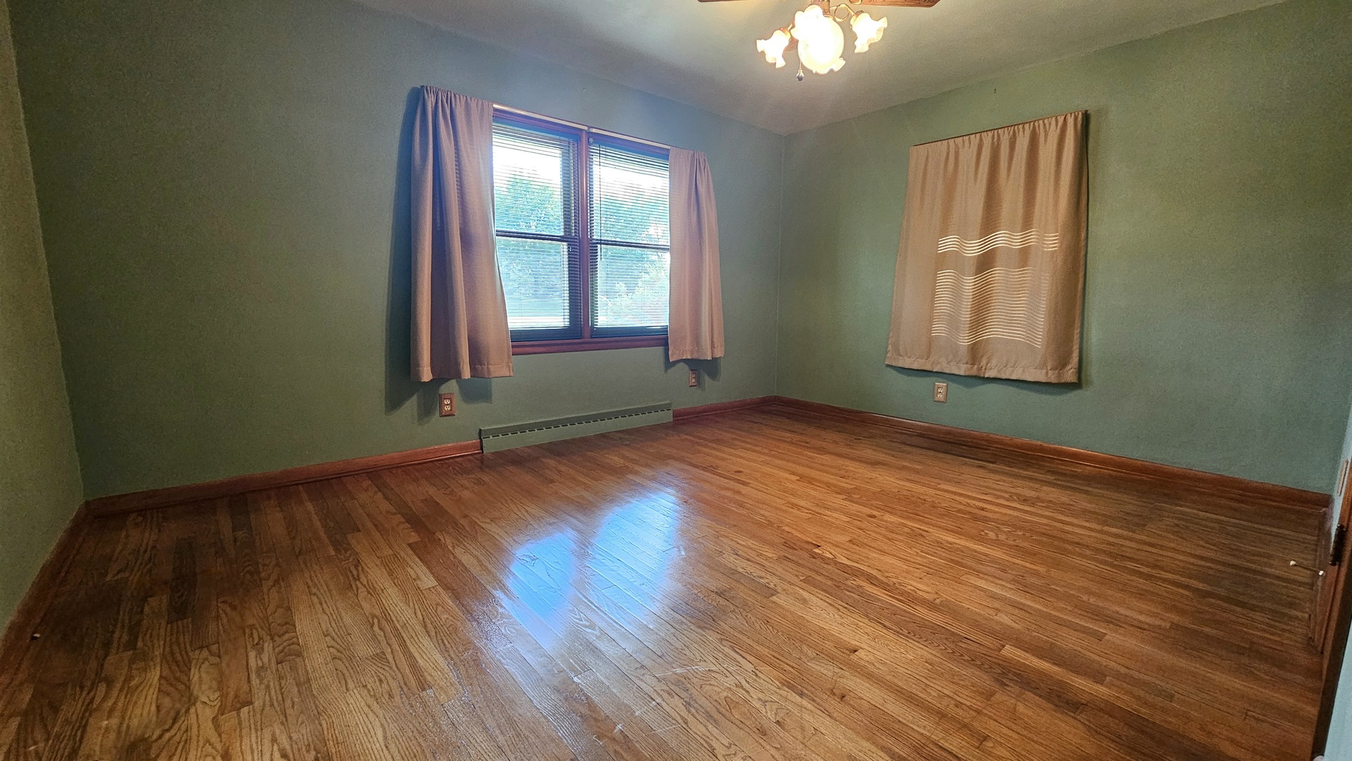 13658 East Flagg Road Rochelle, IL 61068 - Photo 16 of 65 an empty room with wooden floor and windows