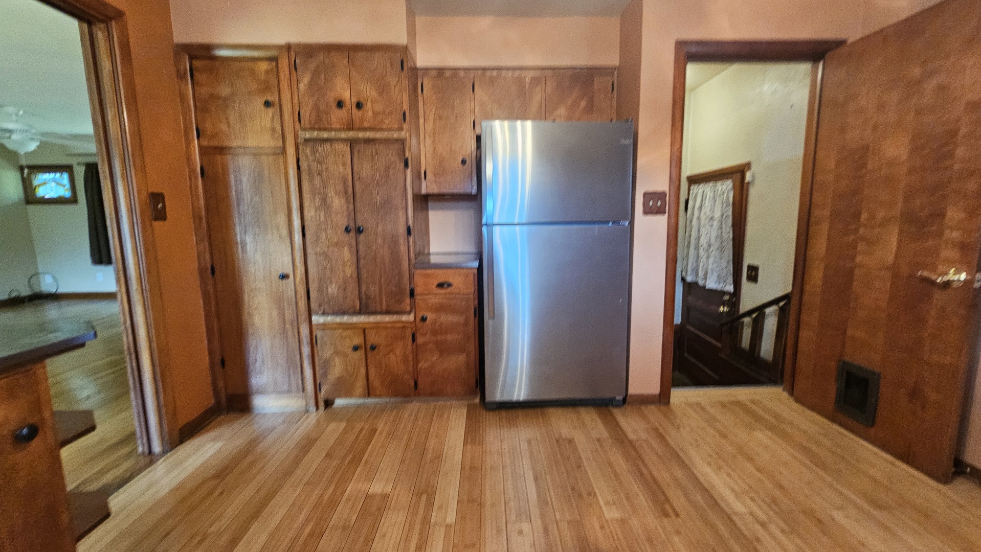13658 East Flagg Road Rochelle, IL 61068 - Photo 29 of 65 a view of a refrigerator in kitchen and wooden floor