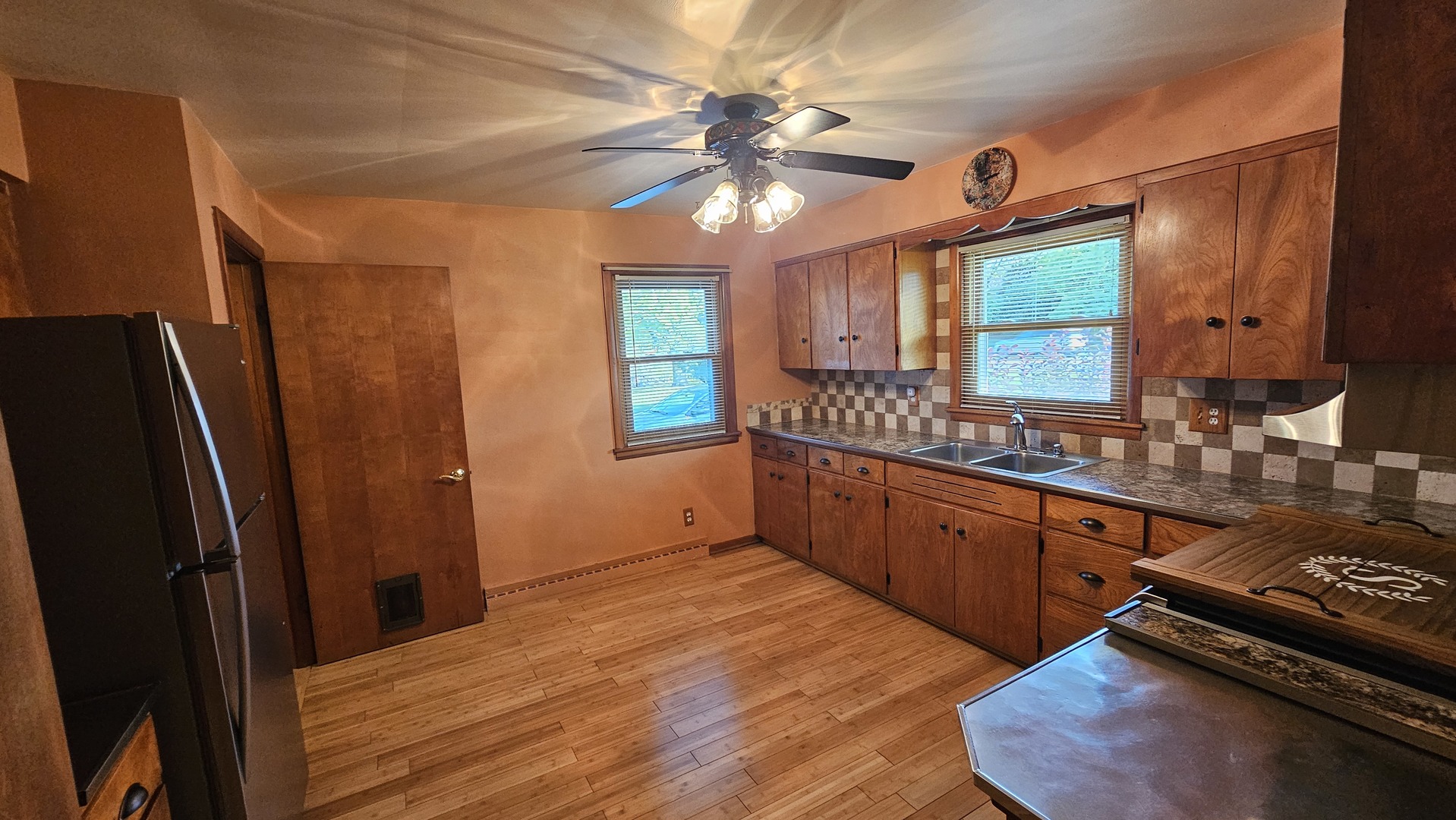 13658 East Flagg Road Rochelle, IL 61068 - Photo 32 of 65 a kitchen with stainless steel appliances granite countertop a refrigerator a sink dishwasher a stove and white countertops with wooden floor
