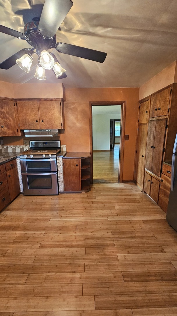 13658 East Flagg Road Rochelle, IL 61068 - Photo 33 of 65 a view of kitchen with furniture and wooden floor