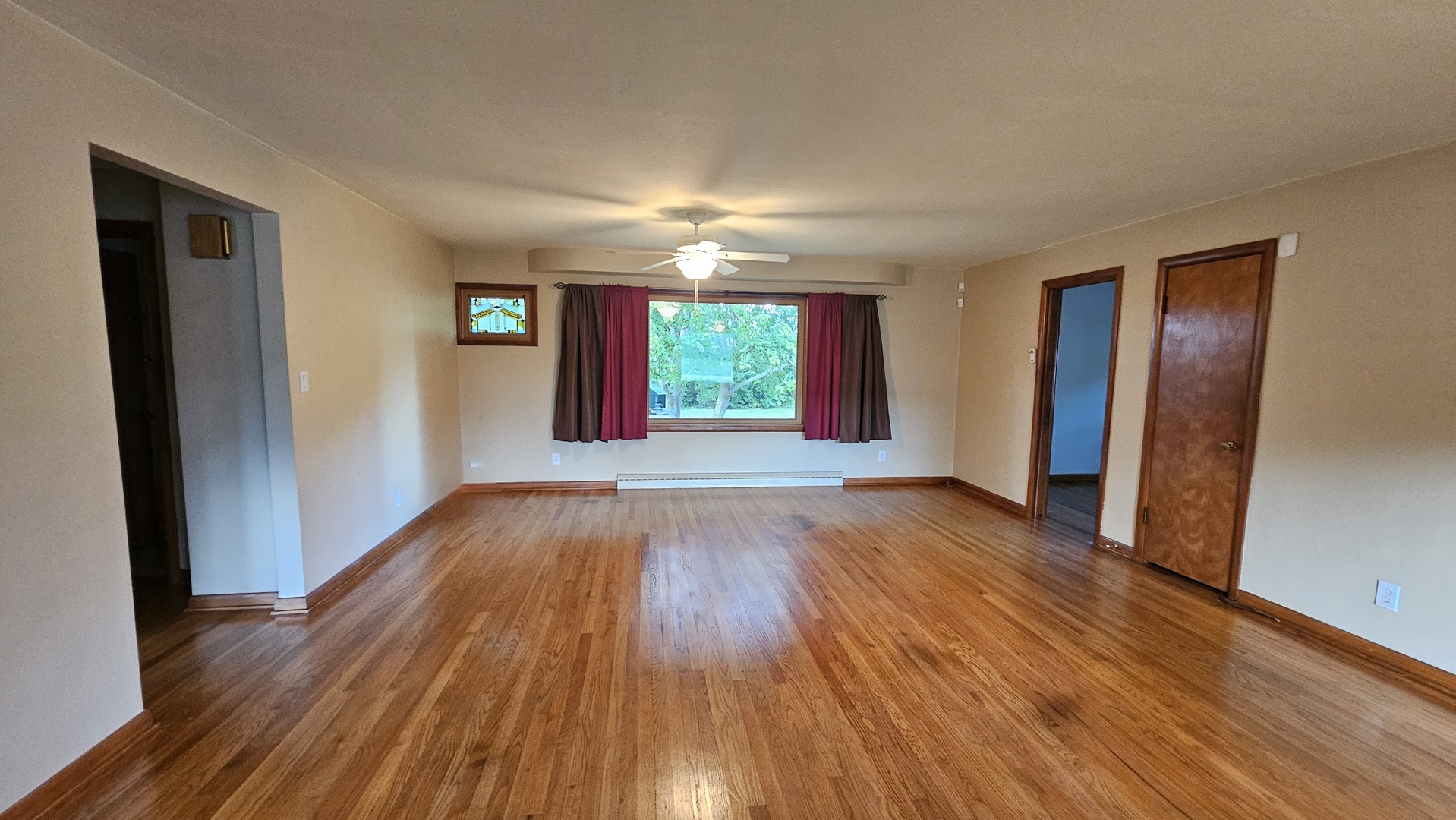 13658 East Flagg Road Rochelle, IL 61068 - Photo 5 of 65 a view of empty room with wooden floor and fan