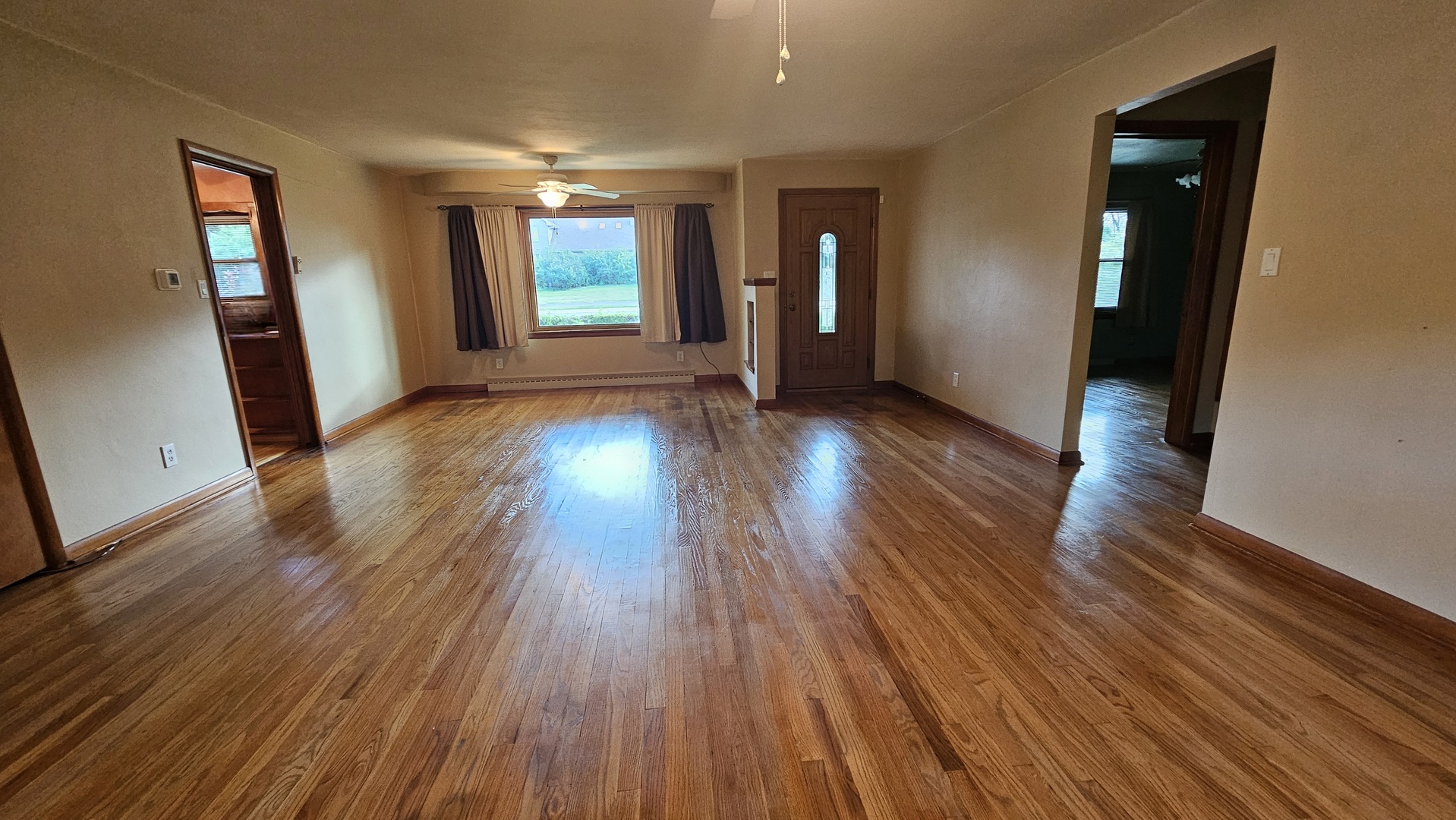 13658 East Flagg Road Rochelle, IL 61068 - Photo 6 of 65 an empty room with wooden floor and windows