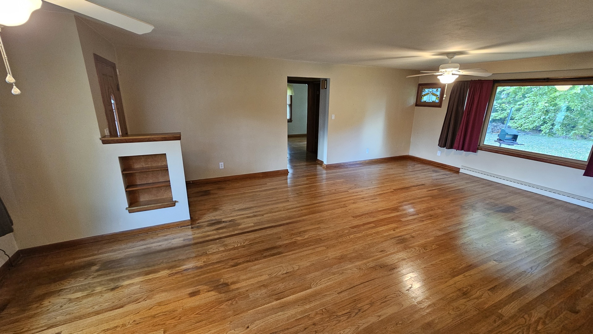 13658 East Flagg Road Rochelle, IL 61068 - Photo 7 of 65 a view of an empty room with wooden floor and a window