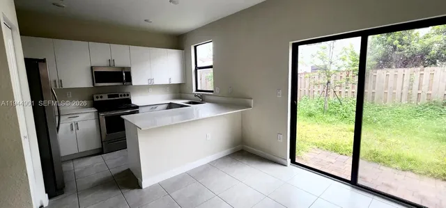 a kitchen with a sink appliances and cabinets