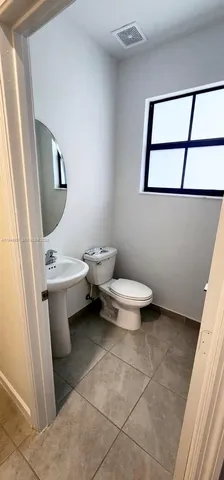 a white toilet sitting next to a white sink
