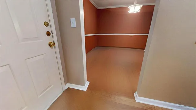 a view of an empty room with glass door and balcony
