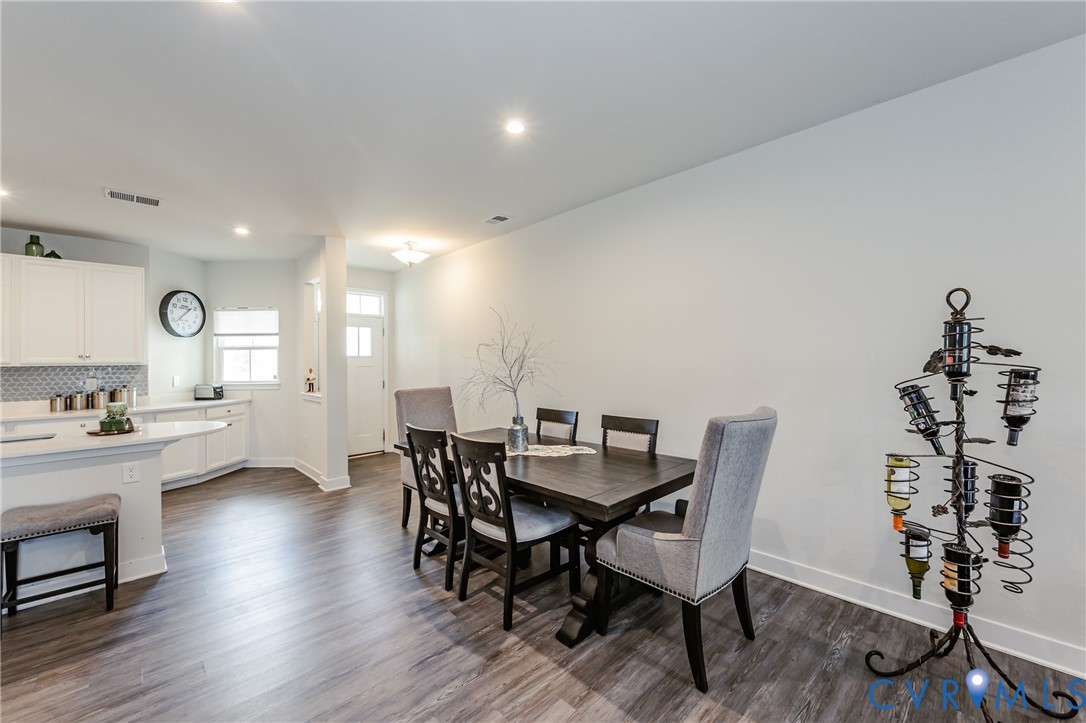 9073 Spring Green Loop Mechanicsville, VA 23116 - Photo 13 of 31 a view of a dining room with furniture and wooden floor