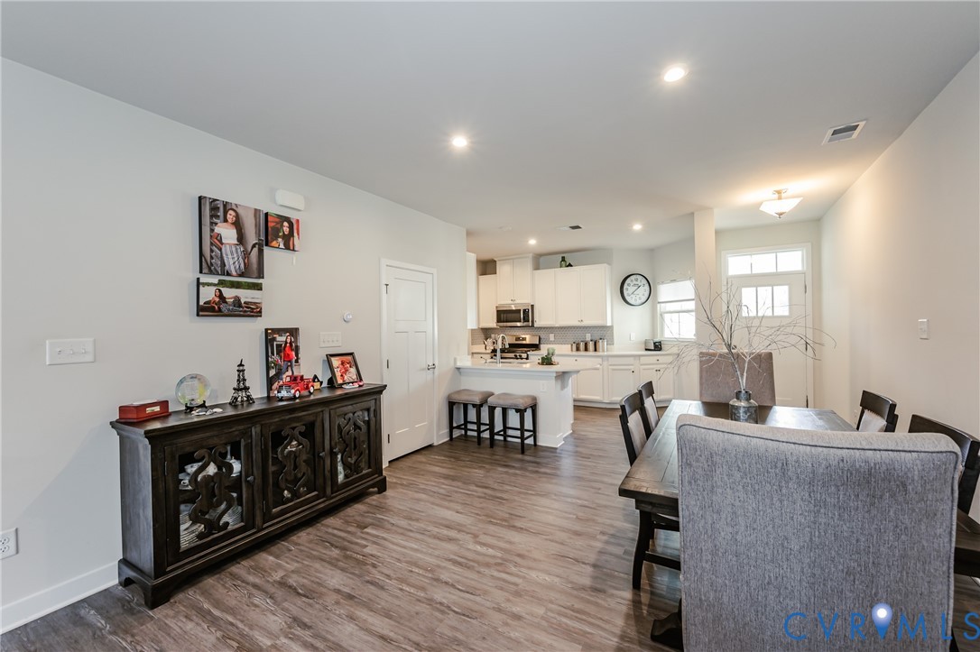 9073 Spring Green Loop Mechanicsville, VA 23116 - Photo 14 of 31 a living room with furniture and a dining room