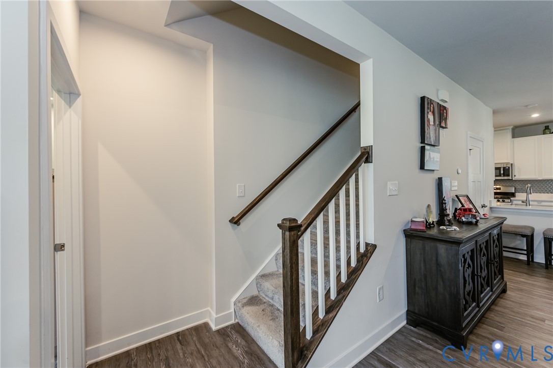 9073 Spring Green Loop Mechanicsville, VA 23116 - Photo 15 of 31 a view of a hallway with wooden floor and stairs