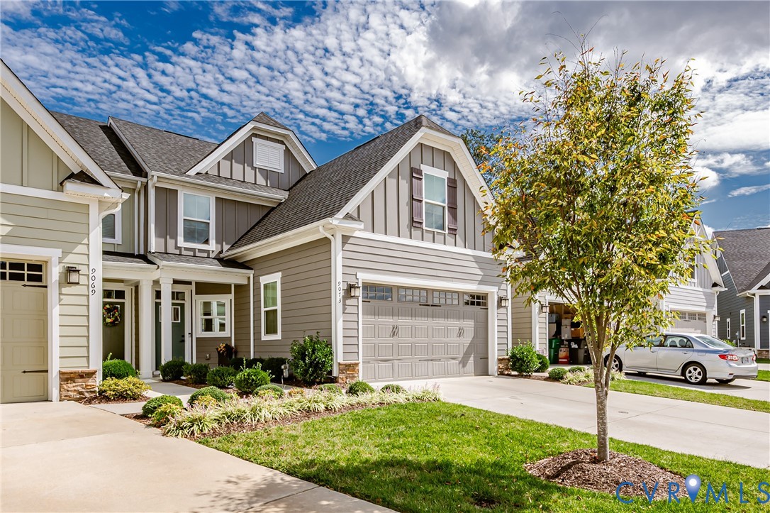 9073 Spring Green Loop Mechanicsville, VA 23116 - Photo 2 of 31 a front view of a house with a yard and garage
