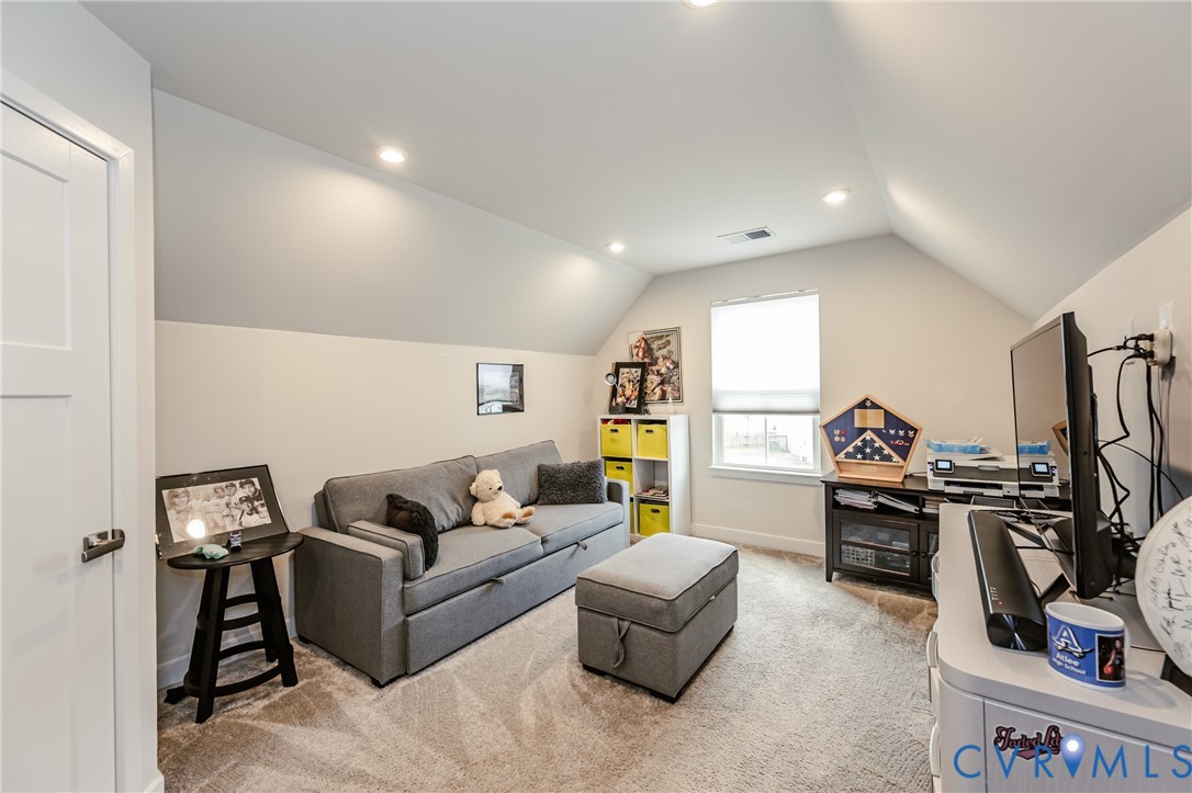 9073 Spring Green Loop Mechanicsville, VA 23116 - Photo 22 of 31 a living room with furniture a flat screen tv and a window