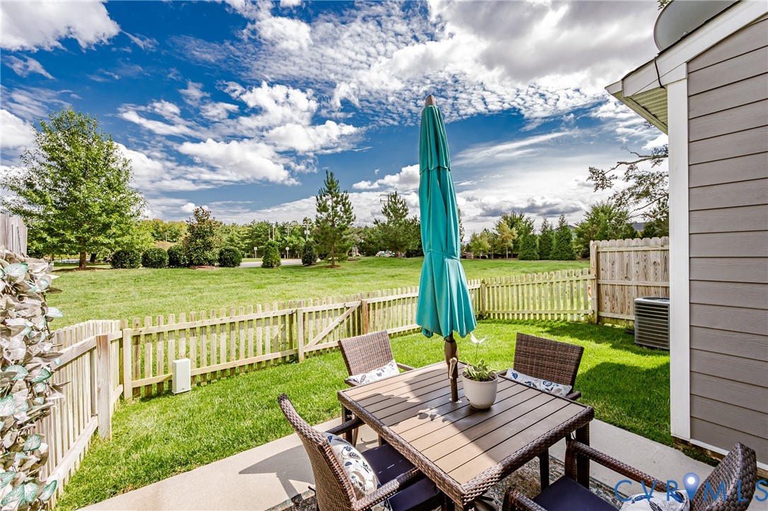 9073 Spring Green Loop Mechanicsville, VA 23116 - Photo 26 of 31 a view of a patio with a table chairs and a backyard