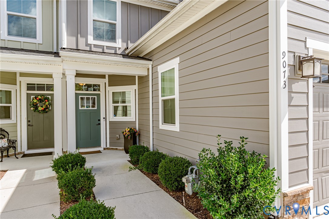 9073 Spring Green Loop Mechanicsville, VA 23116 - Photo 4 of 31 a view of a house with a potted plant and a garage