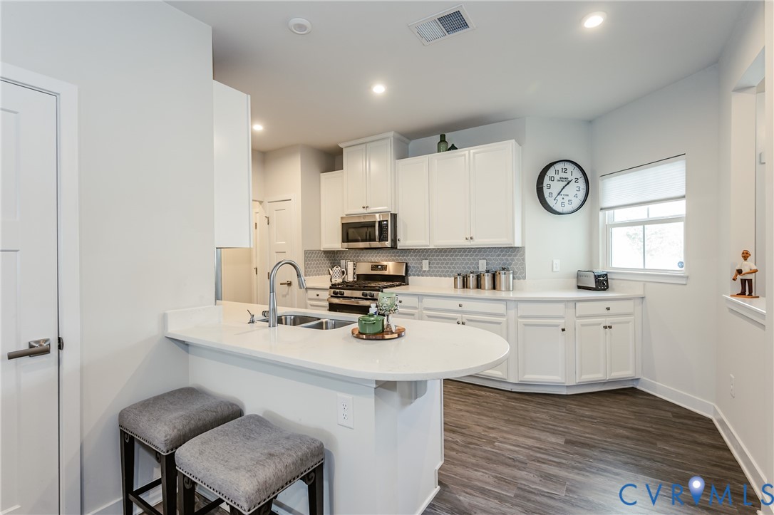 9073 Spring Green Loop Mechanicsville, VA 23116 - Photo 8 of 31 a kitchen with a sink cabinets and wooden floor