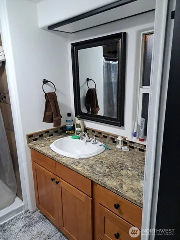 a bathroom with a sink and mirror