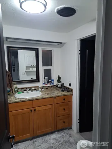 a bathroom with a double vanity sink and a mirror