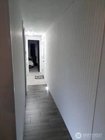 a view of a hallway with wooden floor