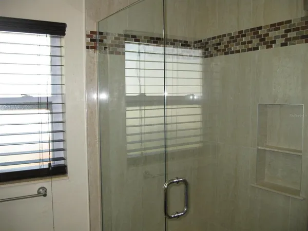a bathroom with a shower and a sink