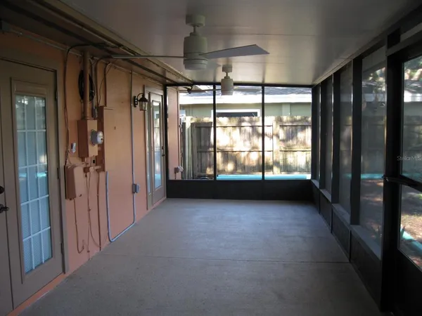 a view of a room with window and ceiling fan