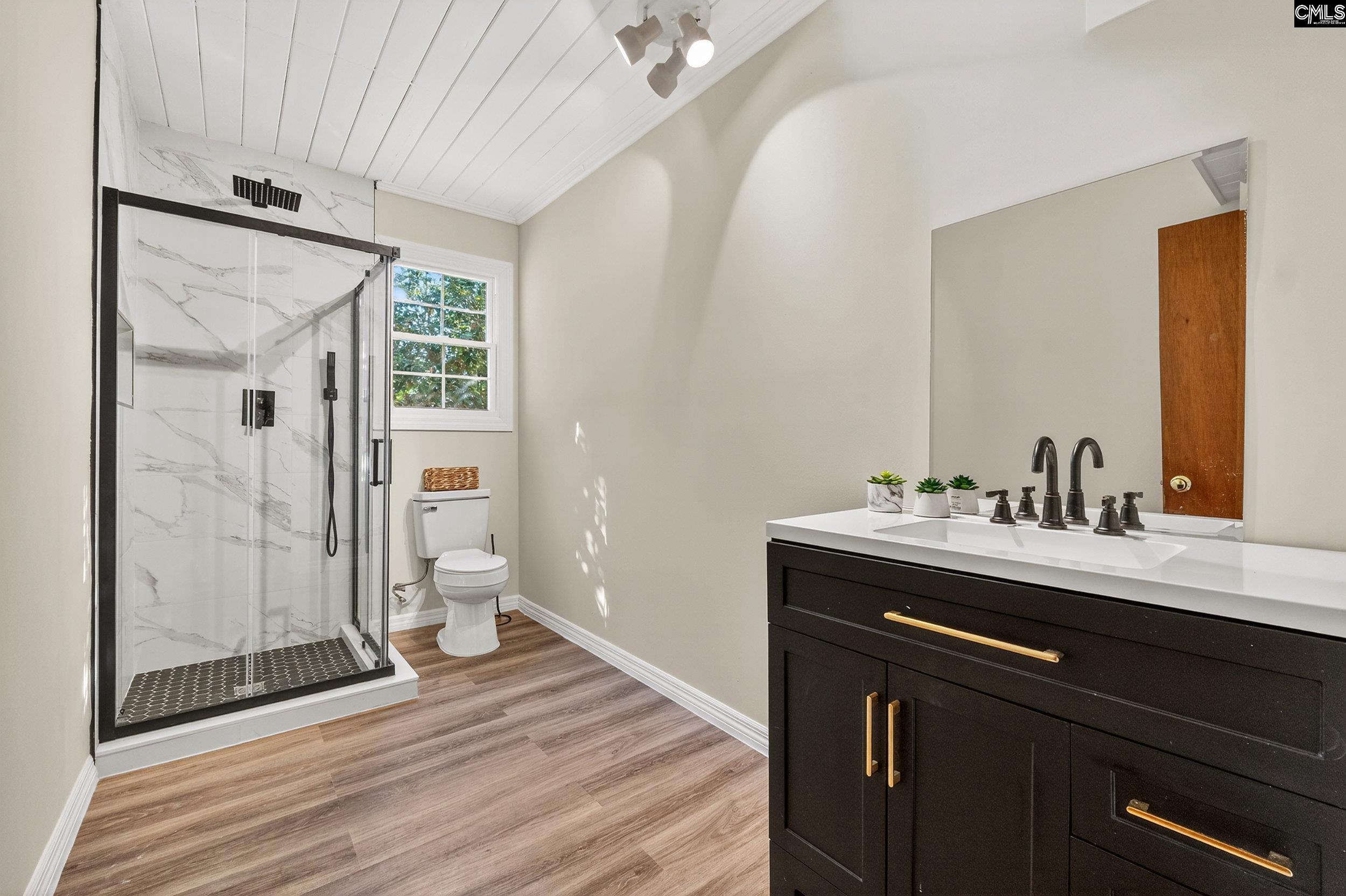 729 Magnolia Street Pelion, SC 29123 - Photo 12 of 32 a view of bathroom with a sink mirror and shower