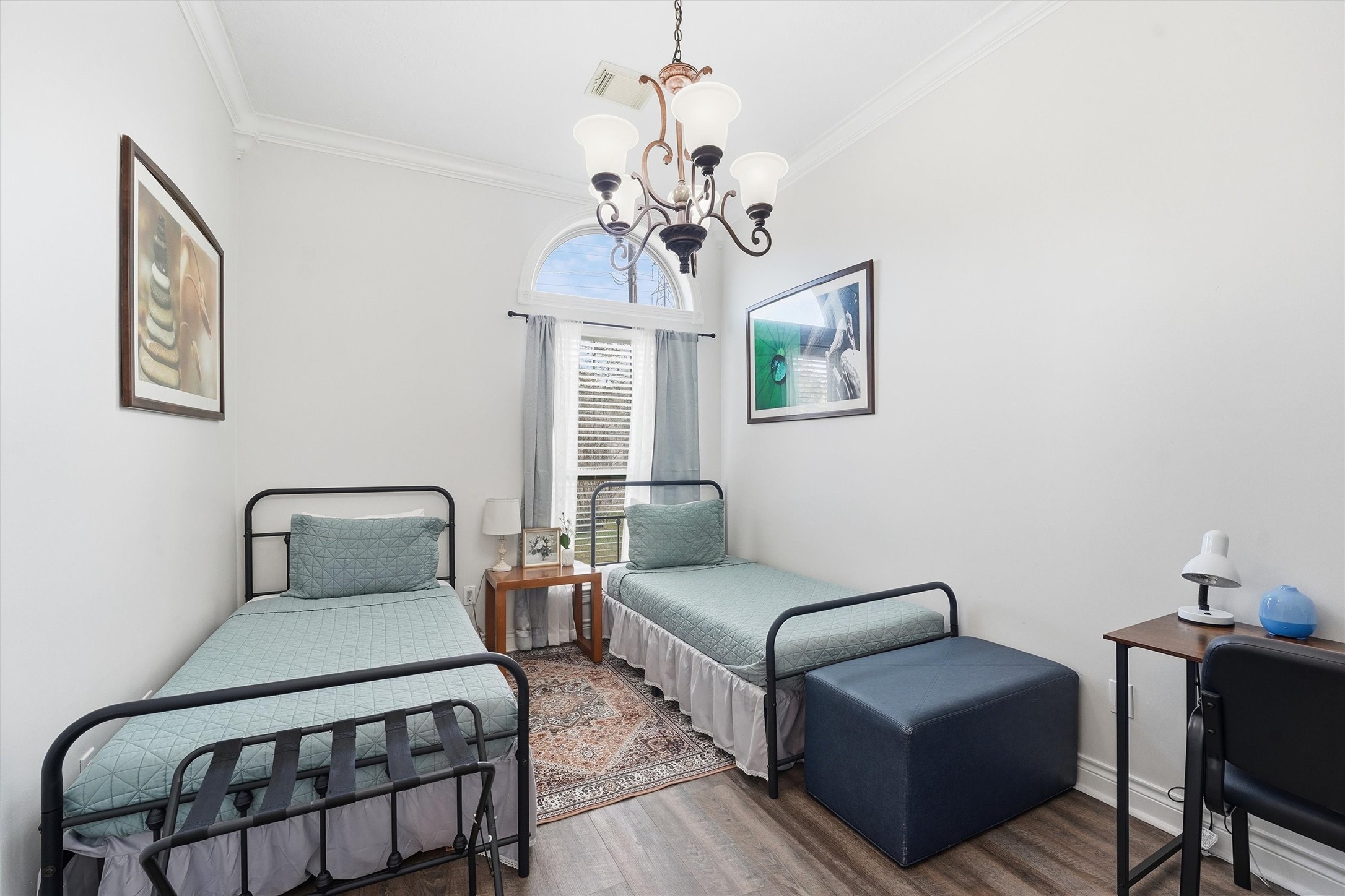 14103 Smith Road Humble, TX 77396 - Photo 13 of 39 a bedroom with furniture and a chandelier