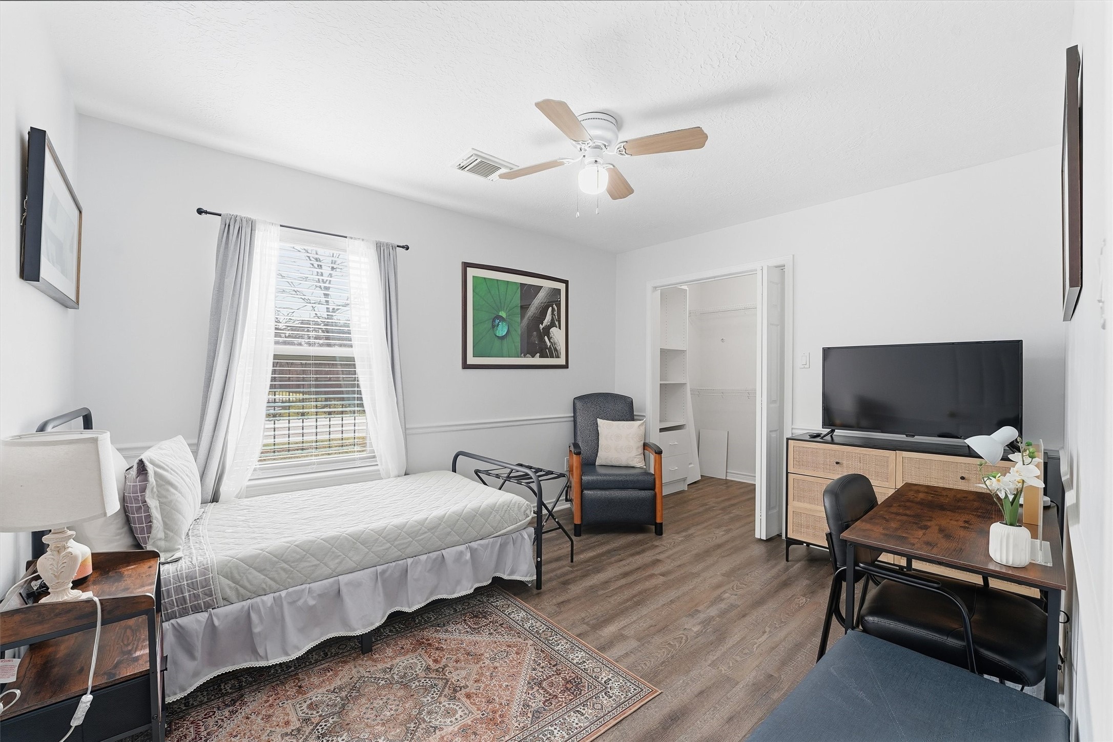 14103 Smith Road Humble, TX 77396 - Photo 15 of 39 a bedroom with a bed and a flat screen tv