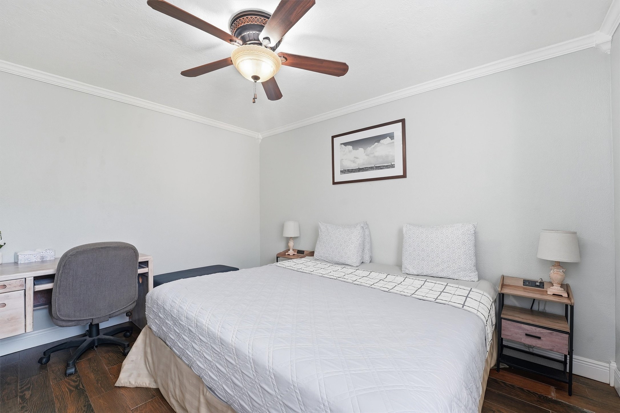 14103 Smith Road Humble, TX 77396 - Photo 24 of 39 a bedroom with a bed and a chandelier