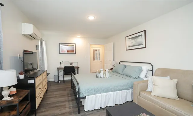 a bedroom with furniture and a flat screen tv