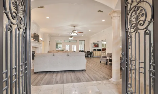 a living room with furniture and a chandelier