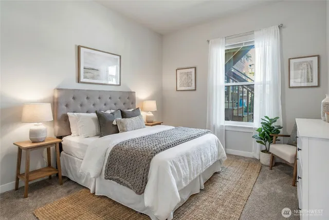 a bedroom with a bed and a potted plant