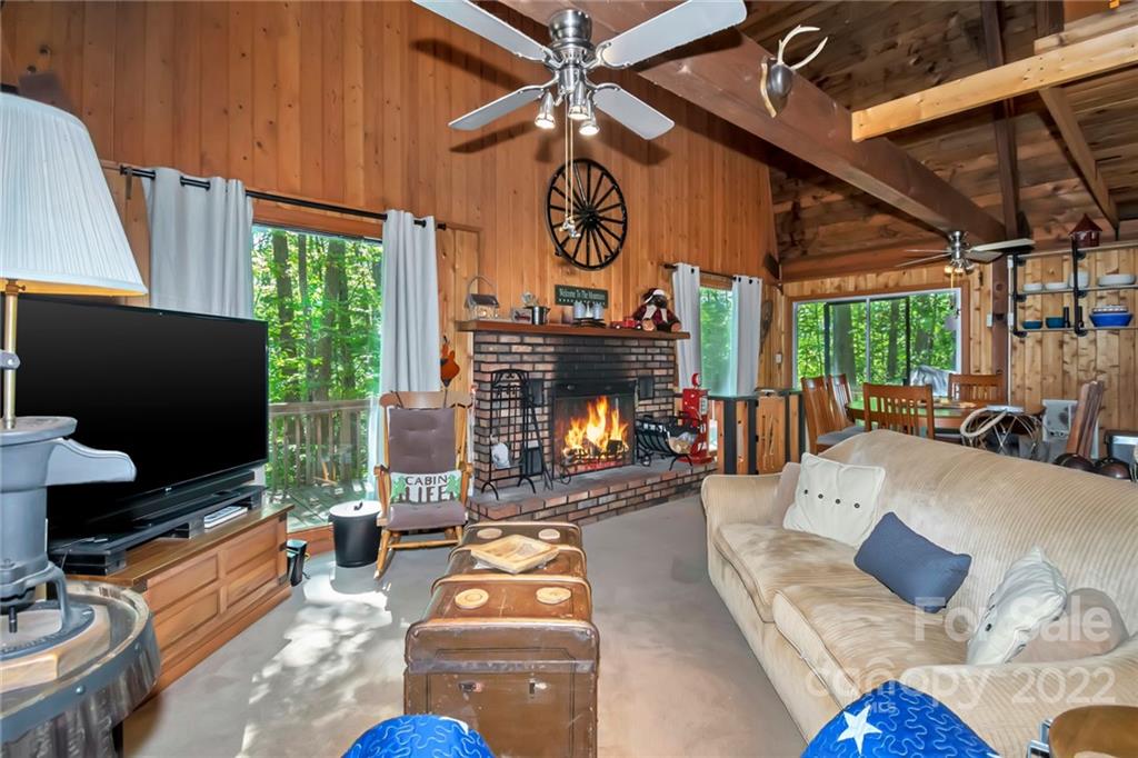 813 Pine Ridge Road, Unit 56 Beech Mountain, NC 28604 - Photo 8 of 37 a living room with furniture a fireplace and a flat screen tv