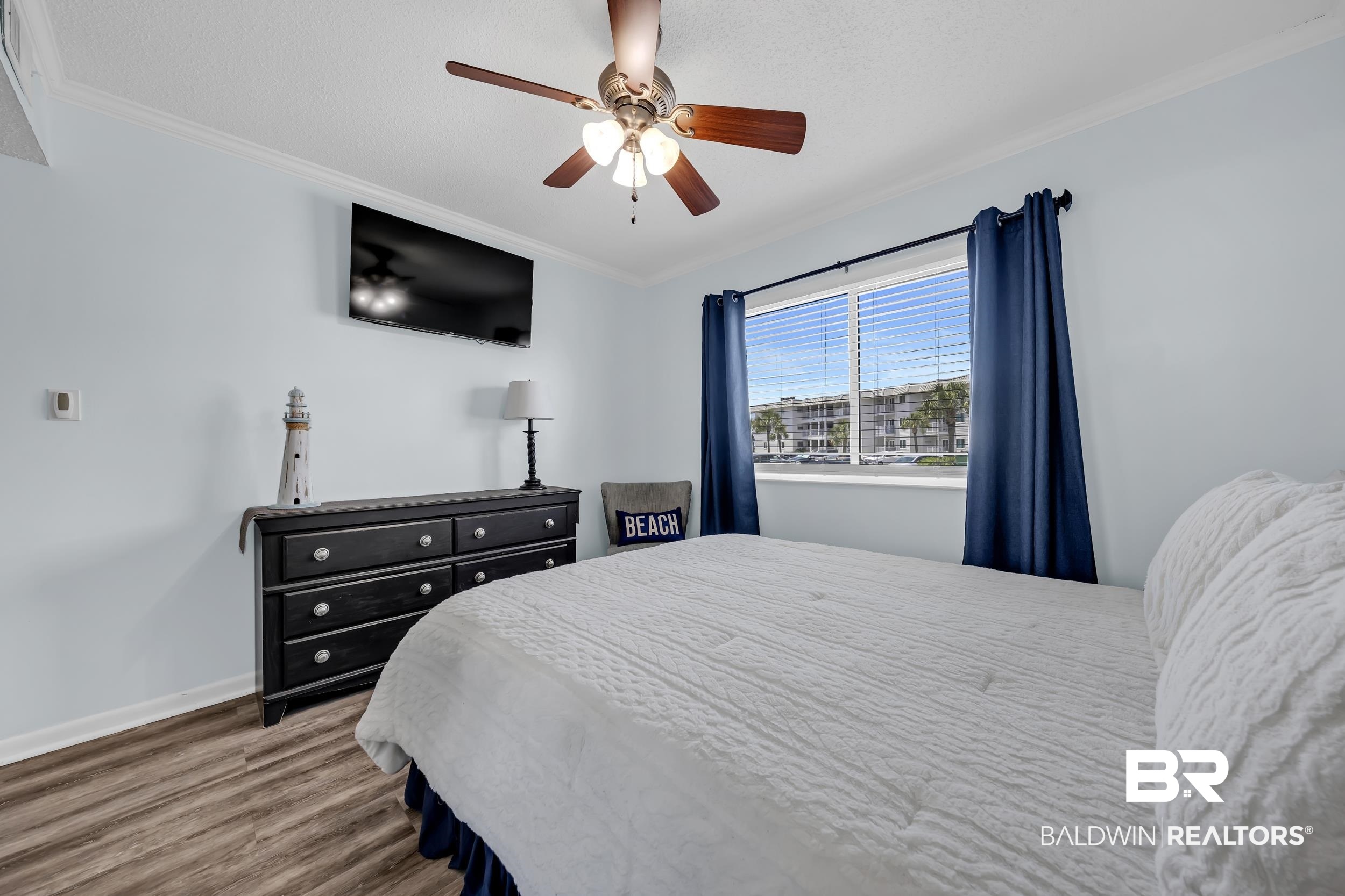 400 Plantation Road, Unit 2118 Gulf Shores, AL 36542 - Photo 16 of 59 Room featuring a ceiling fan with integrated lighting, wood-finish flooring, and crown molding