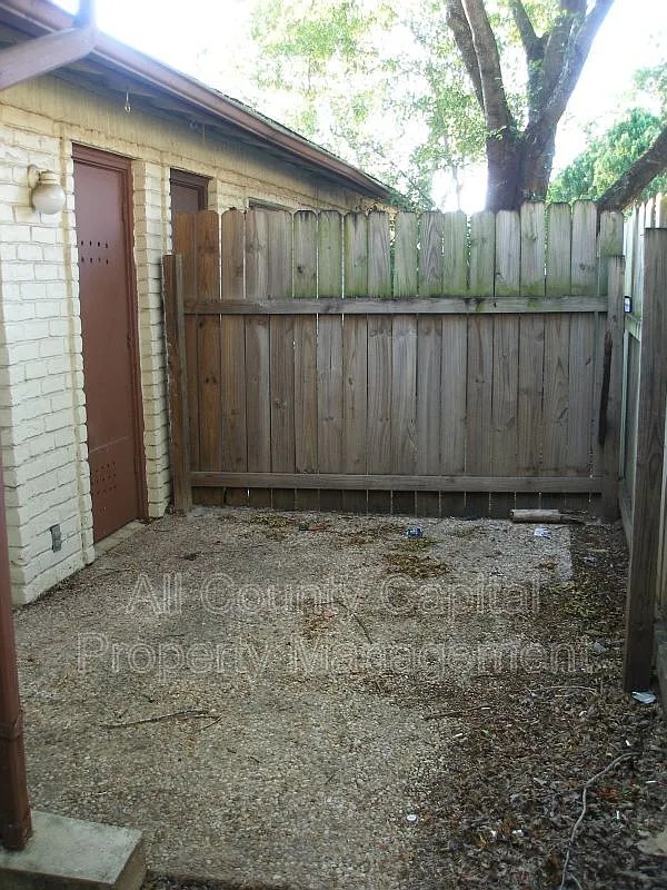 6508 South 1st Street, Unit 101 Austin, TX 78745 - Photo 2 of 8 a view of backyard with wooden fence