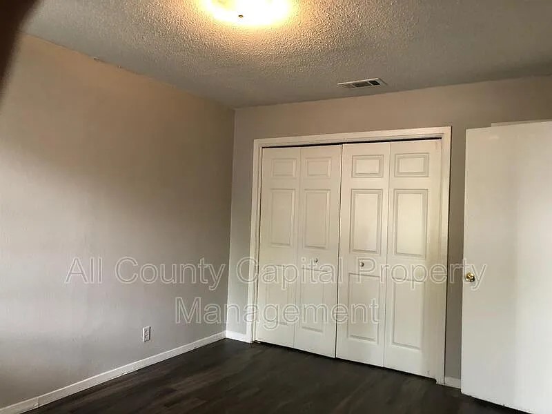 6508 South 1st Street, Unit 101 Austin, TX 78745 - Photo 4 of 8 wooden floor in an empty room