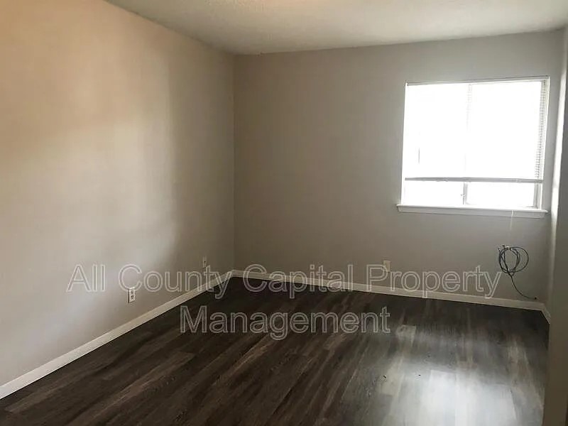 6508 South 1st Street, Unit 101 Austin, TX 78745 - Photo 5 of 8 a view of a room with wooden floor and a window