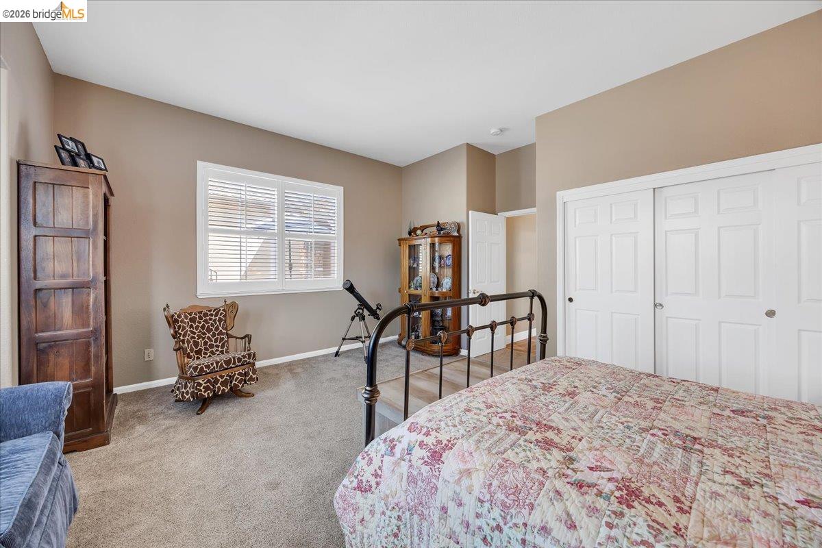 158 Rock Ridge Lane Copperopolis, CA 95228 - Photo 42 of 72 Carpeted room featuring a window with horizontal blinds, neutral wall tones, and white bi-fold closet doors