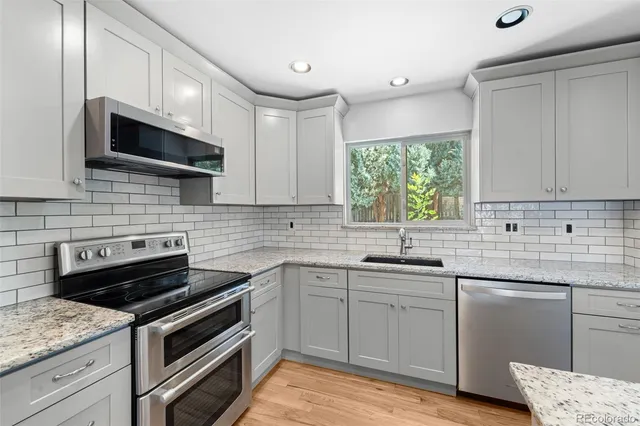 a kitchen with a sink stove and microwave