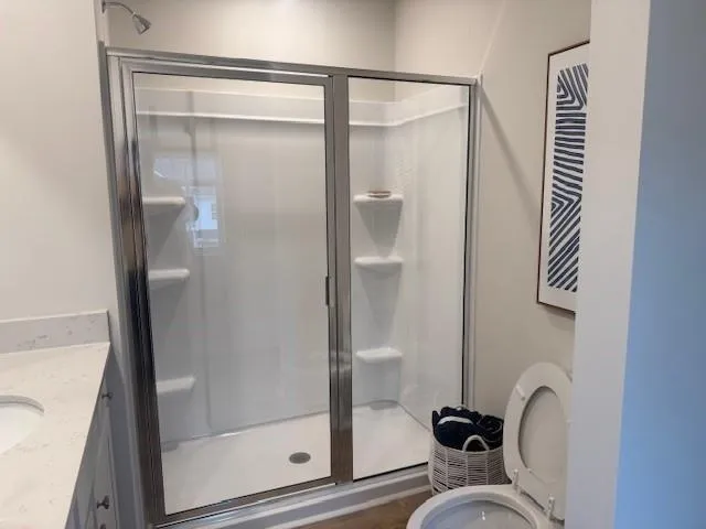 a bathroom with a shower and mirror