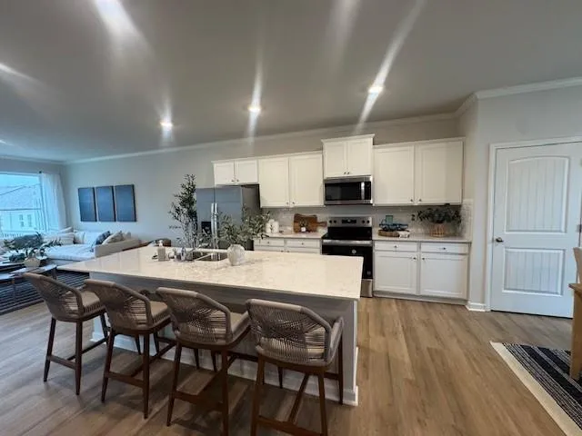 a kitchen with a table chairs stove and cabinets