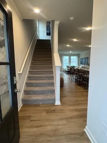 a view of entryway and hall with wooden floor