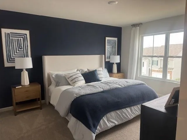 a bed sitting in a bedroom next to a window