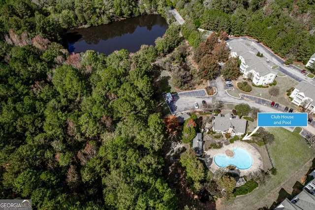 an aerial view of a house with a yard and lake view