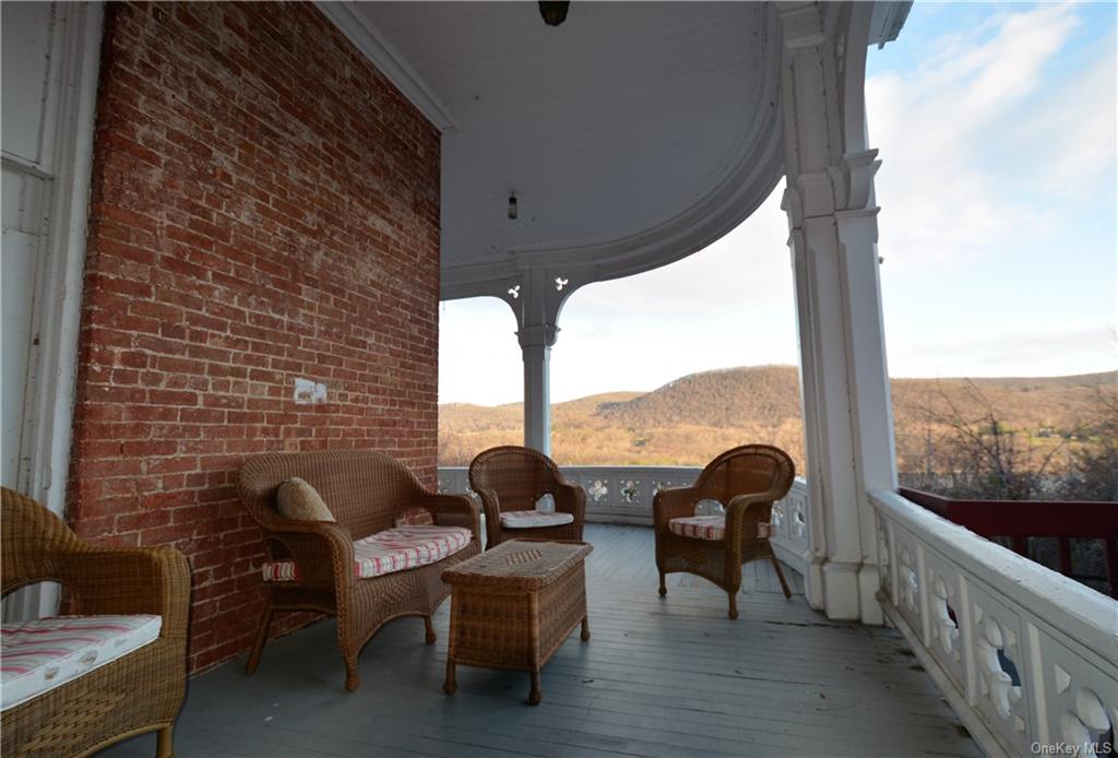 a view of balcony with couch and chairs