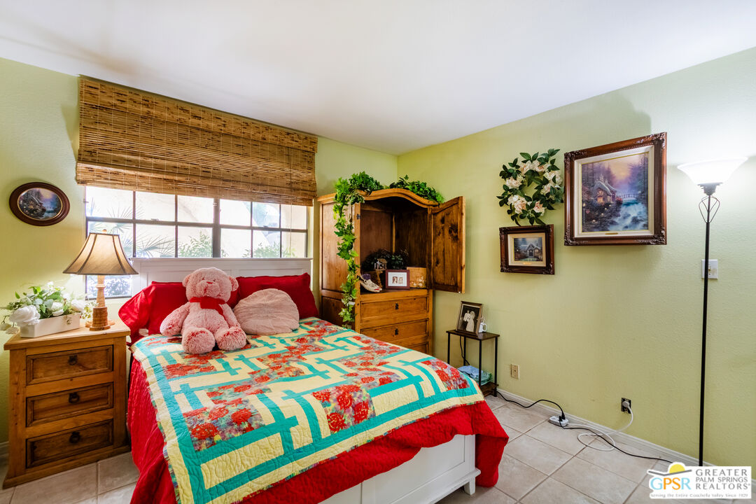 5300 East Waverly Drive, Unit C13 Palm Springs, CA 92264 - Photo 13 of 32 a bedroom with a bed and a dresser in it