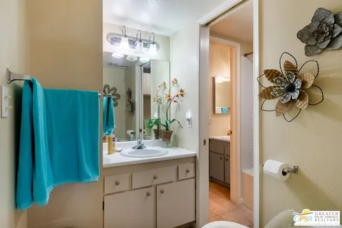 a bathroom with a sink vanity and a mirror